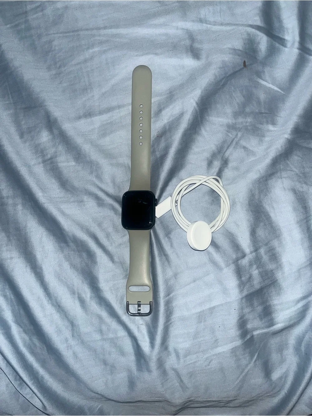 Apple Watch with Beige Sport Band and White Charger